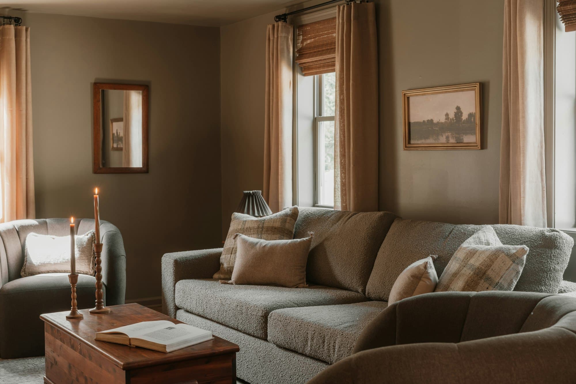 A warm living room with a sofa and armchair